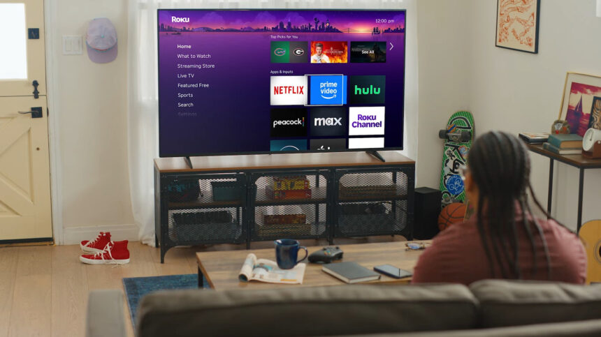 person watching Roku TV interface with Netflix Prime Video and Hulu apps in a modern living room